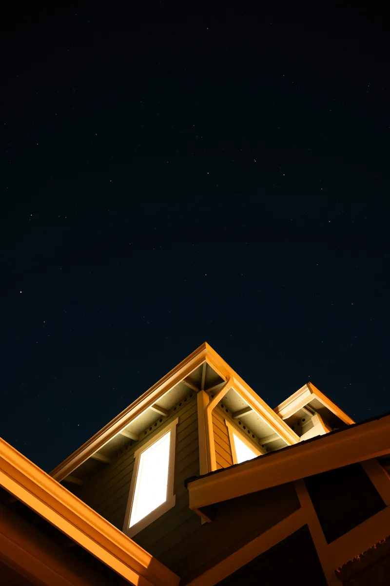 A bottom up shot of a house and the stars